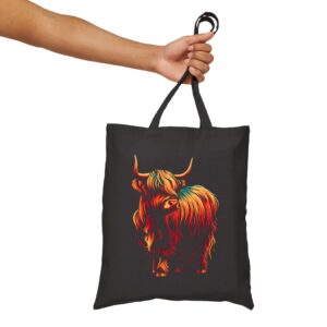 Holding the highland cow tote bag by strap handles